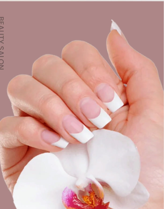 Manicured nails holding an orchid